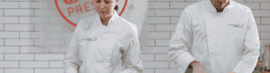 Morrison Healthcare chefs in white uniforms standing in front of brick wall with red Pressed logo above them