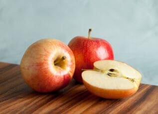 Red and green apples on wooden cutting board, fresh fruit for healthy snack or cooking ingredient