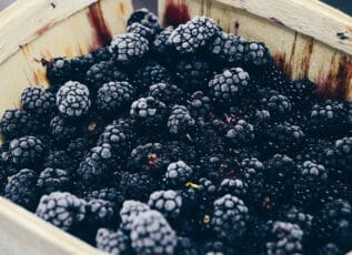 Fresh blackberries in wooden basket, ripe and ready to eat