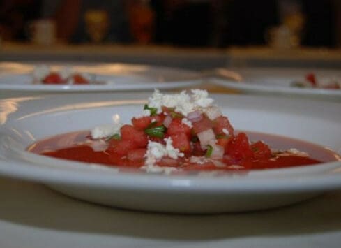 Diced tomatoes with onions and feta cheese appetizer on white plate