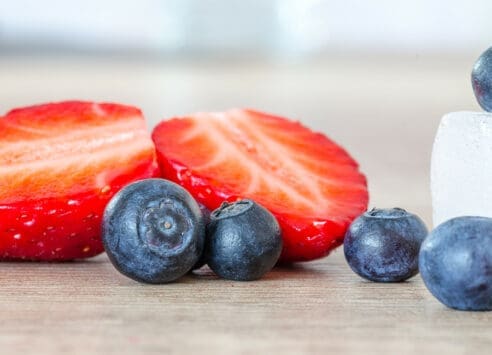 Strawberries and blueberries on a wooden table, ingredients for a healthy snack or dessert