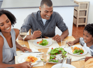 Family enjoying healthy meal together at dinner table