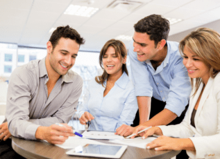 Business team discussing paperwork together in office