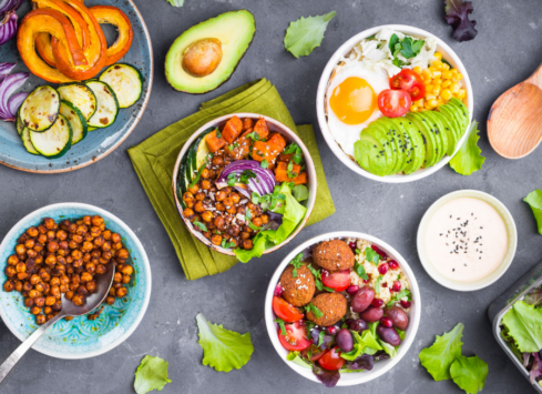 Healthy vegan salad bowls with fresh vegetables, avocado, and roasted chickpeas