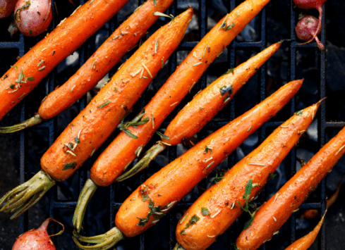 Roasted carrots with herbs on a grill rack