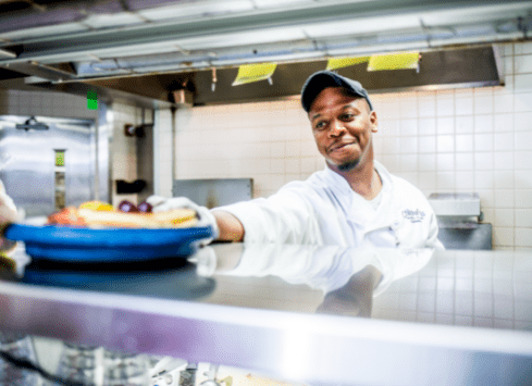 Morrison Healthcare chef smiling in commercial kitchen
