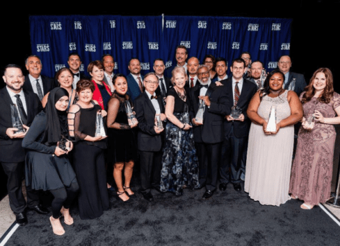 Morrison Healthcare leadership team holding awards at annual STARS event