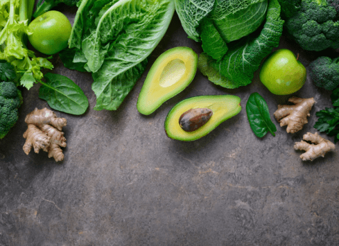 Green vegetables: lettuce, avocado, ginger on gray background for healthy eating and nutrition
