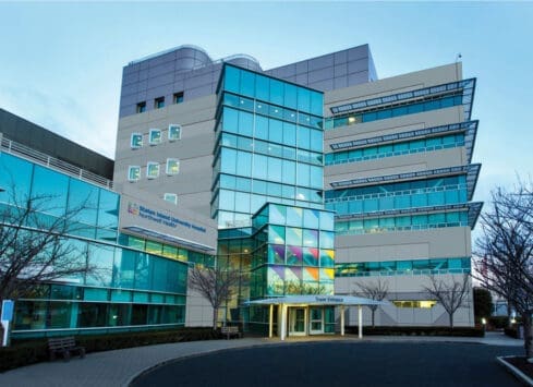 Seattle Children's Hospital building exterior with colorful glass facade against clear blue sky