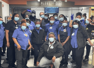 Morrison Healthcare staff at Market St Deli wearing masks and posing for a group photo