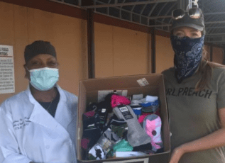Morrison Healthcare employees in masks donating essential items to the community