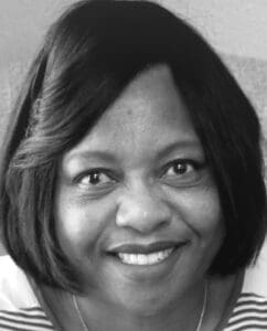 Black and white portrait photo of smiling woman with short dark hair