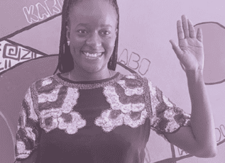 Smiling African woman waving while wearing an embellished top, black and white photo