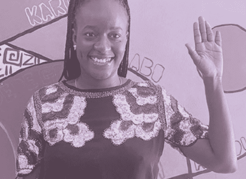 Smiling African woman waving while wearing an embellished top, black and white photo