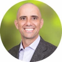 Smiling executive headshot on green background - Morrison Healthcare leader