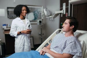 Nurse talking with patient in hospital room