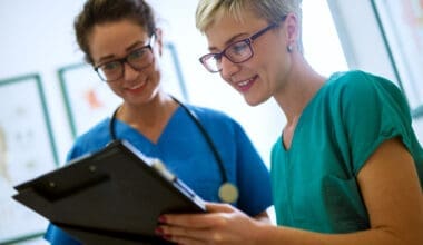 Nurses reviewing medical chart together, smiling