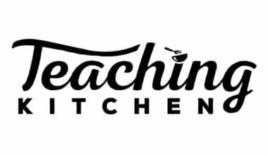 Teaching Kitchen logo in black cursive font on white background