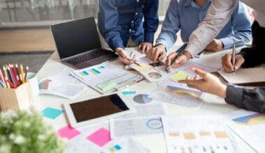 Business team reviewing financial reports and charts at office desk