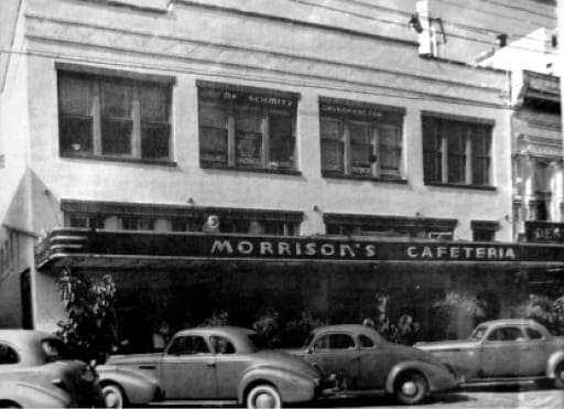 Morrison's Cafeteria vintage black and white photo with 1940s cars parked outside city building