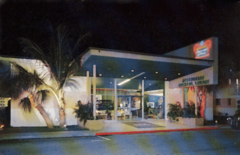 Morrison Healthcare cafeteria entrance at night with neon sign and palm trees