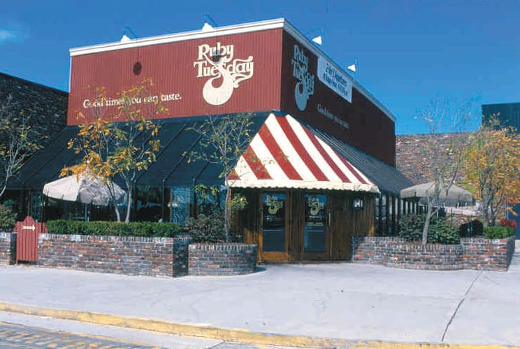 Ruby Tuesday casual dining restaurant exterior with striped awning and brick facade