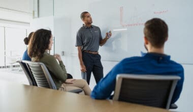 Morrison Healthcare employee presenting to seated colleagues in a conference room