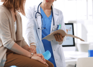 Doctor and patient reviewing medical records on tablet in office