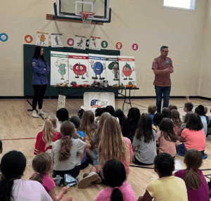Chef Z presenting in front of a school