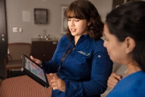 Morrison staff looking at an ipad