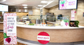 Morrison Healthcare-designed retail dining space featuring the colorful Beet Root culinary concept, fresh ingredients, serving stations, and branded signage.